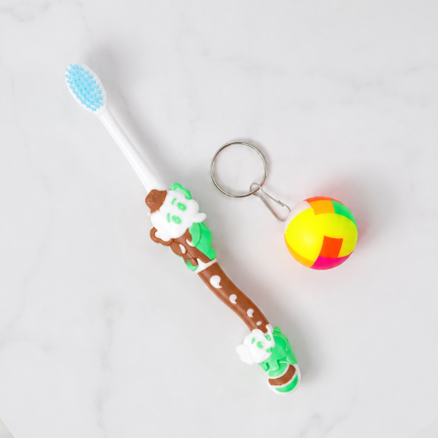 Child's hand holding colorful ergonomic kids toothbrush for oral care